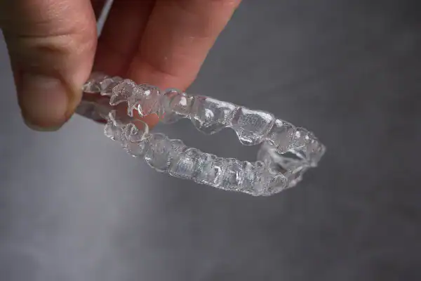 The Retainer Challenge: Do You Still Fit? 4 A person holding clear retainers 459c39f2 edfb 4e6f a74a 3345d87b2523 2