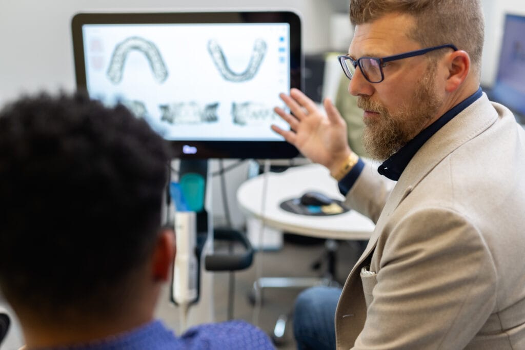 Doctor discusing images on screen