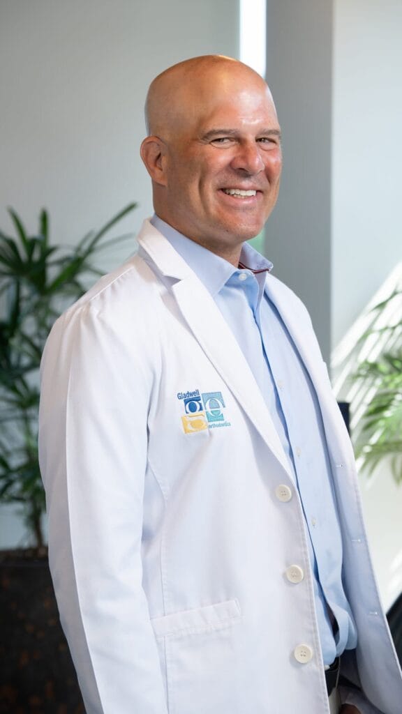 Laster Headshot White Coat scaled 1