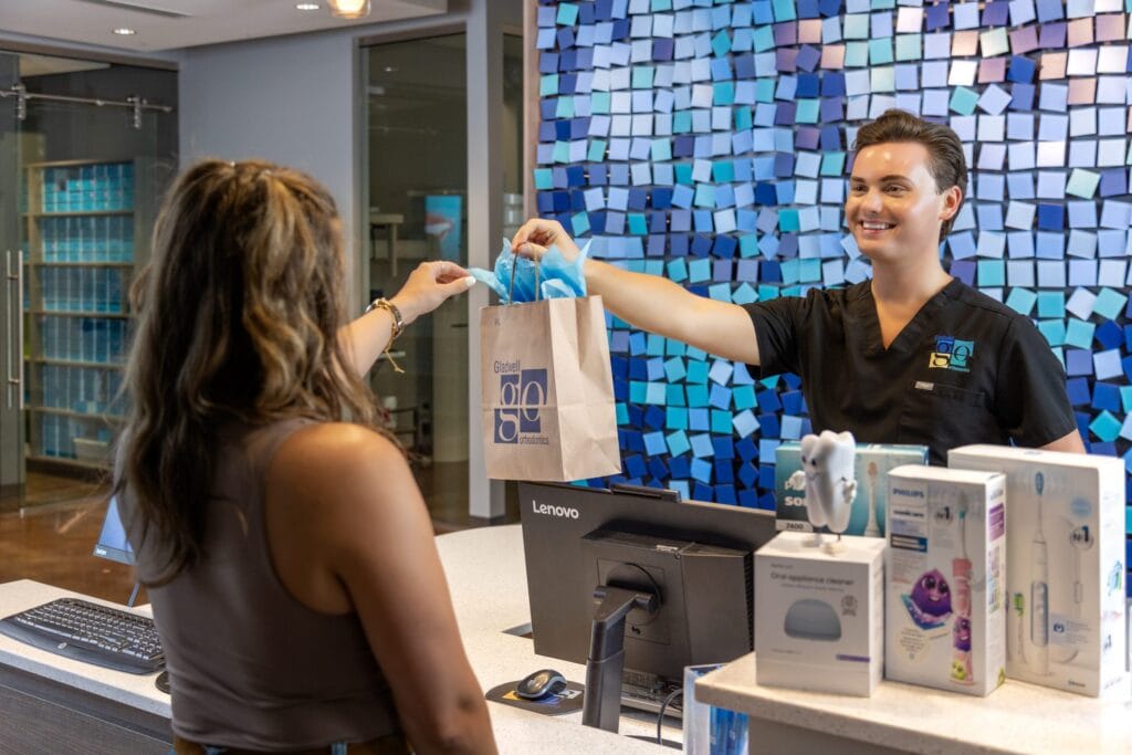 New patient receiving a welcome bag at the front desk